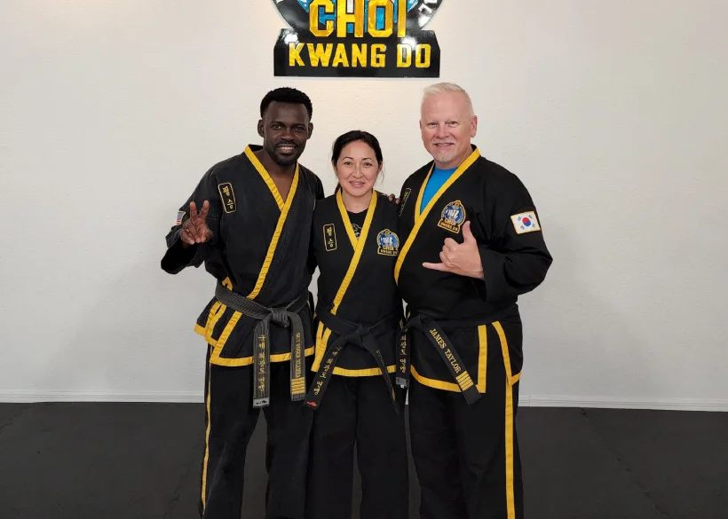 Adult martial arts participants kicking pads during stress-relief workout session