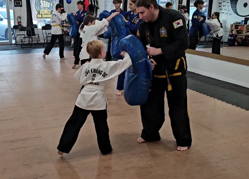 Happy kids in High Springs learning martial arts, improving balance, coordination, and having fun while building life skills.