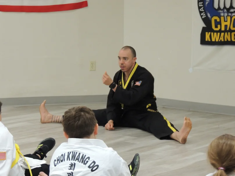 Adult martial arts students relaxing and socializing after training in High Springs gym